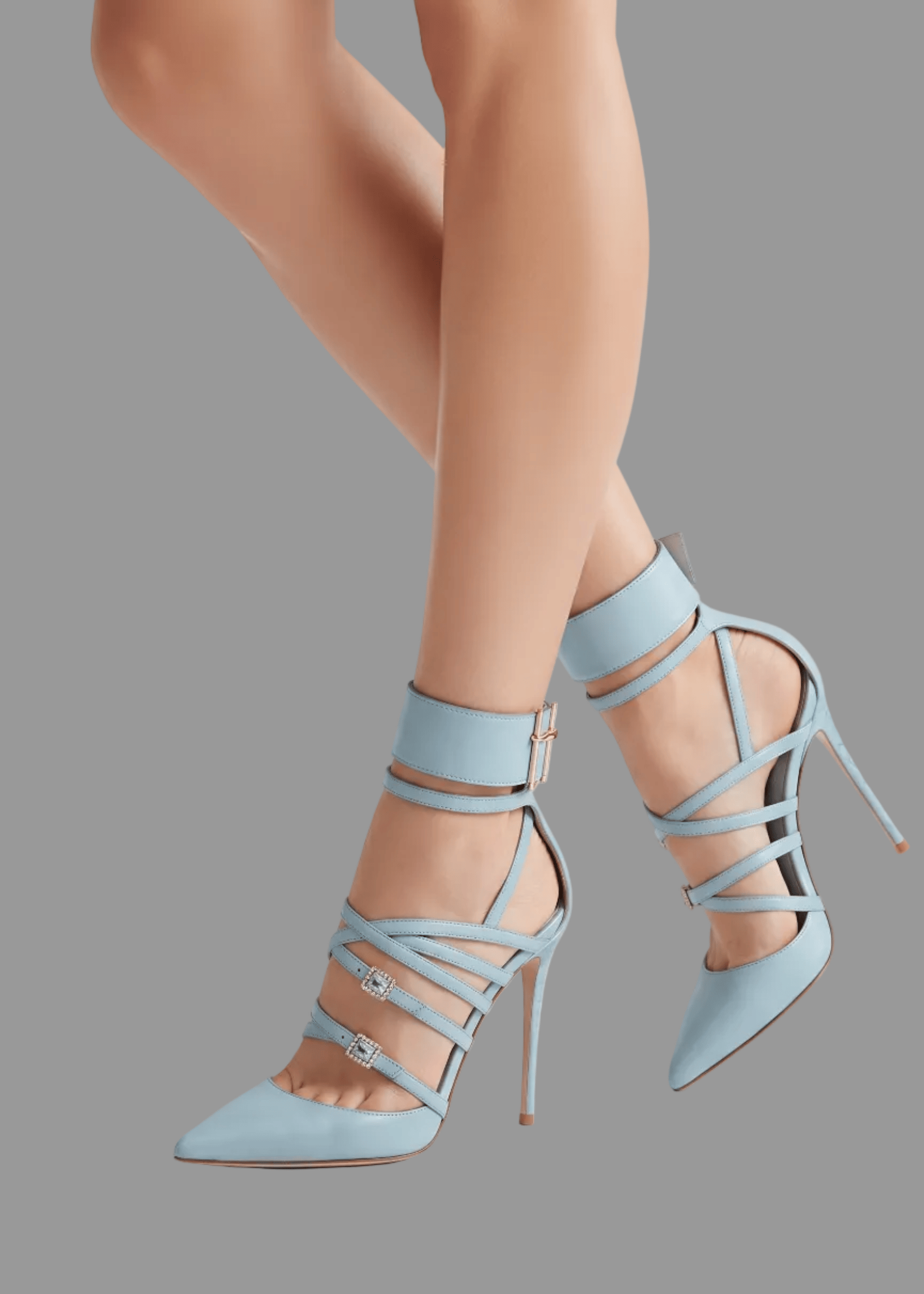 Light blue high-heeled shoes with strappy design worn by a person on a light gray background.