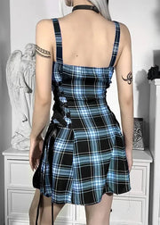 Person wearing a blue and black plaid dress in an indoor setting.