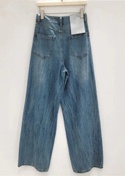 Blue jeans hanging on a white wall