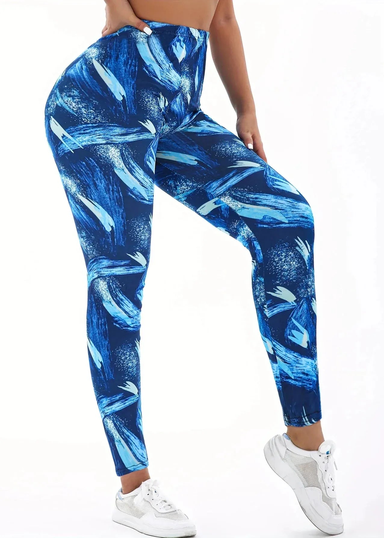 Blue and white patterned leggings worn by a person on a white background