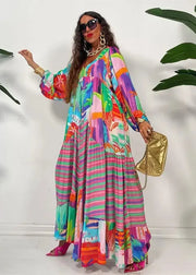 Woman wearing a colorful dress with a gold handbag against a white background