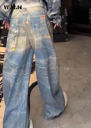 Person wearing blue jeans with patches in an indoor setting
