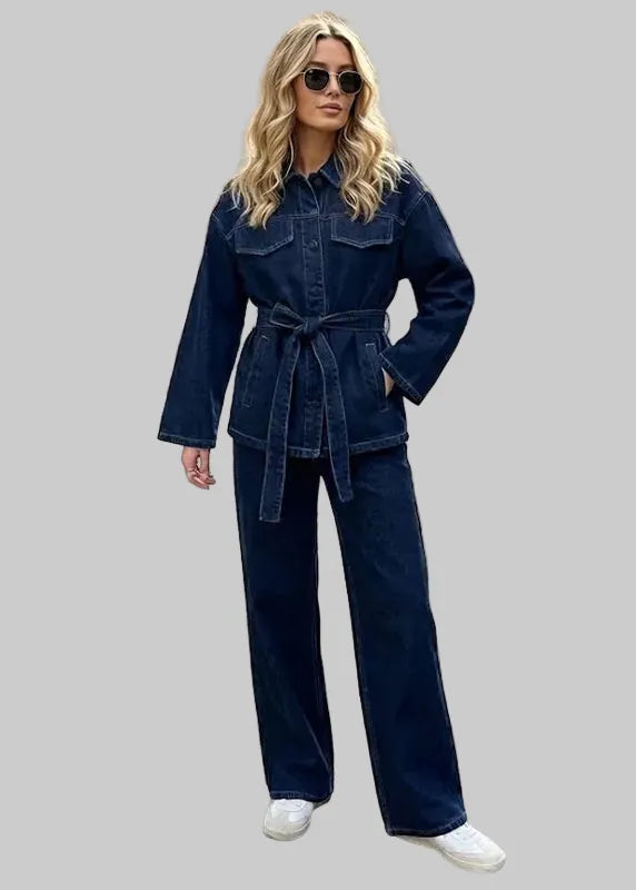 Woman in a denim outfit standing on a city street.