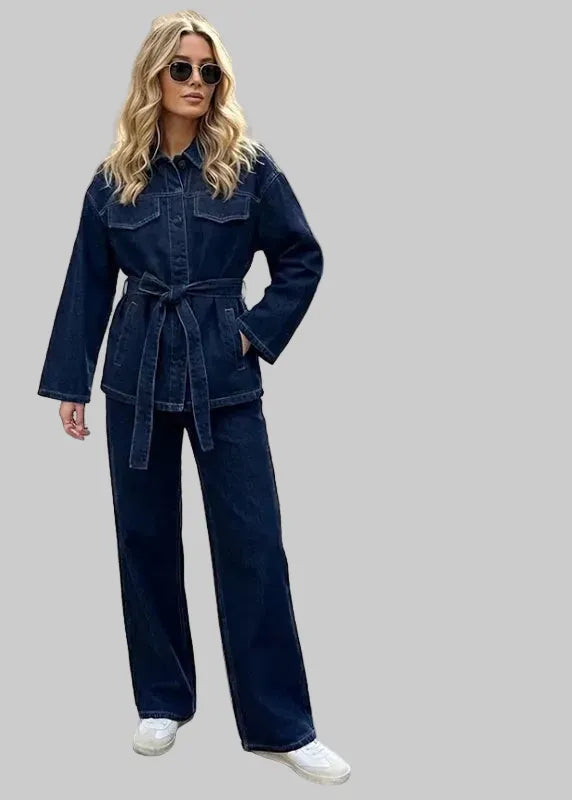 Woman wearing a denim outfit with jacket and pants, standing on a street.