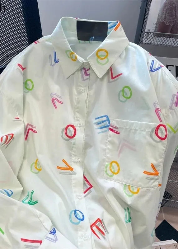 White shirt with colorful geometric patterns on a blurred background