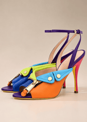 Colorful high-heeled shoes with a geometric design on a beige background