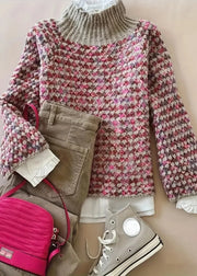 Floral sweater with pink bag and beige shoes on a neutral background