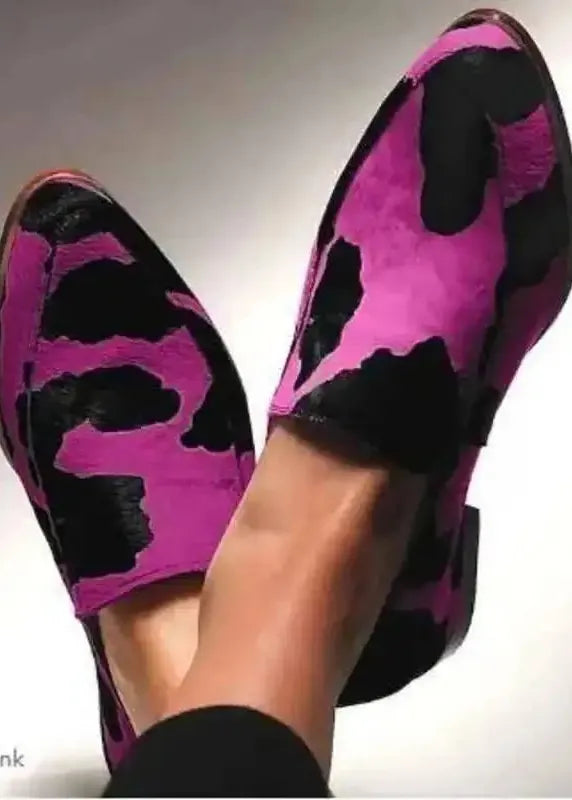 Purple and black patterned shoes on a neutral background