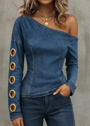 Denim off-shoulder top with gold accents on a plain background