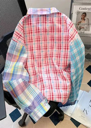 Colorful plaid shirt draped over a chair with magazines on a table in the background