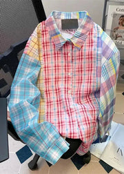 Colorful plaid shirt on a mannequin in a room with a tiled floor and books.