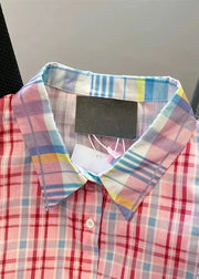 Multicolored plaid shirt with a tag on a plain background