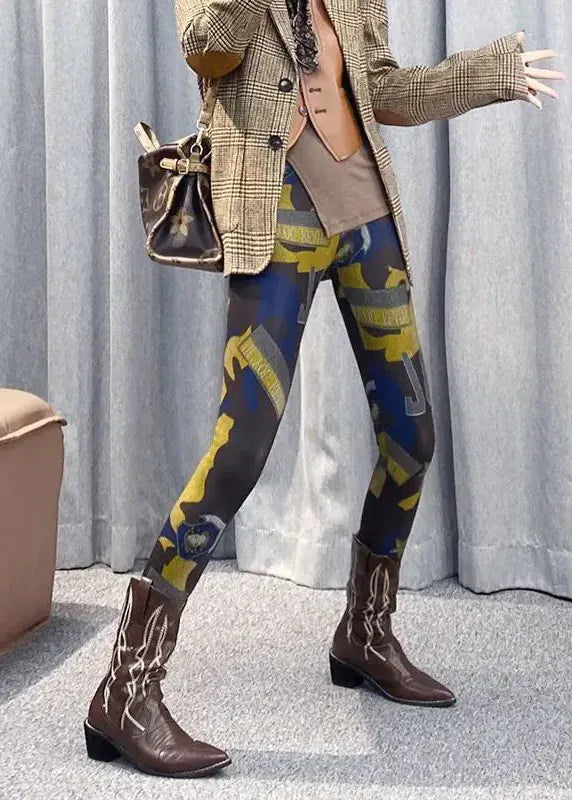 Person wearing patterned leggings and brown boots with a checkered jacket and handbag.