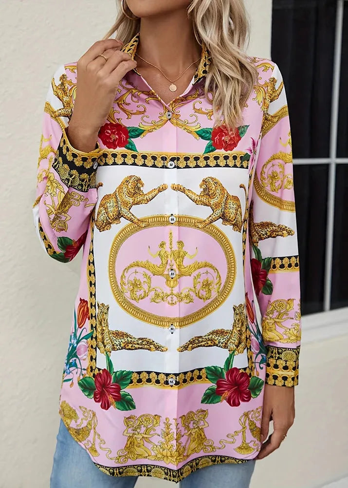 Woman wearing a colorful patterned blouse with floral and baroque design.