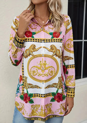 Woman wearing a colorful patterned blouse with floral and baroque design.