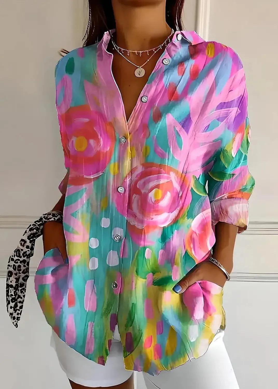 Colorful floral shirt worn by a person against a neutral background