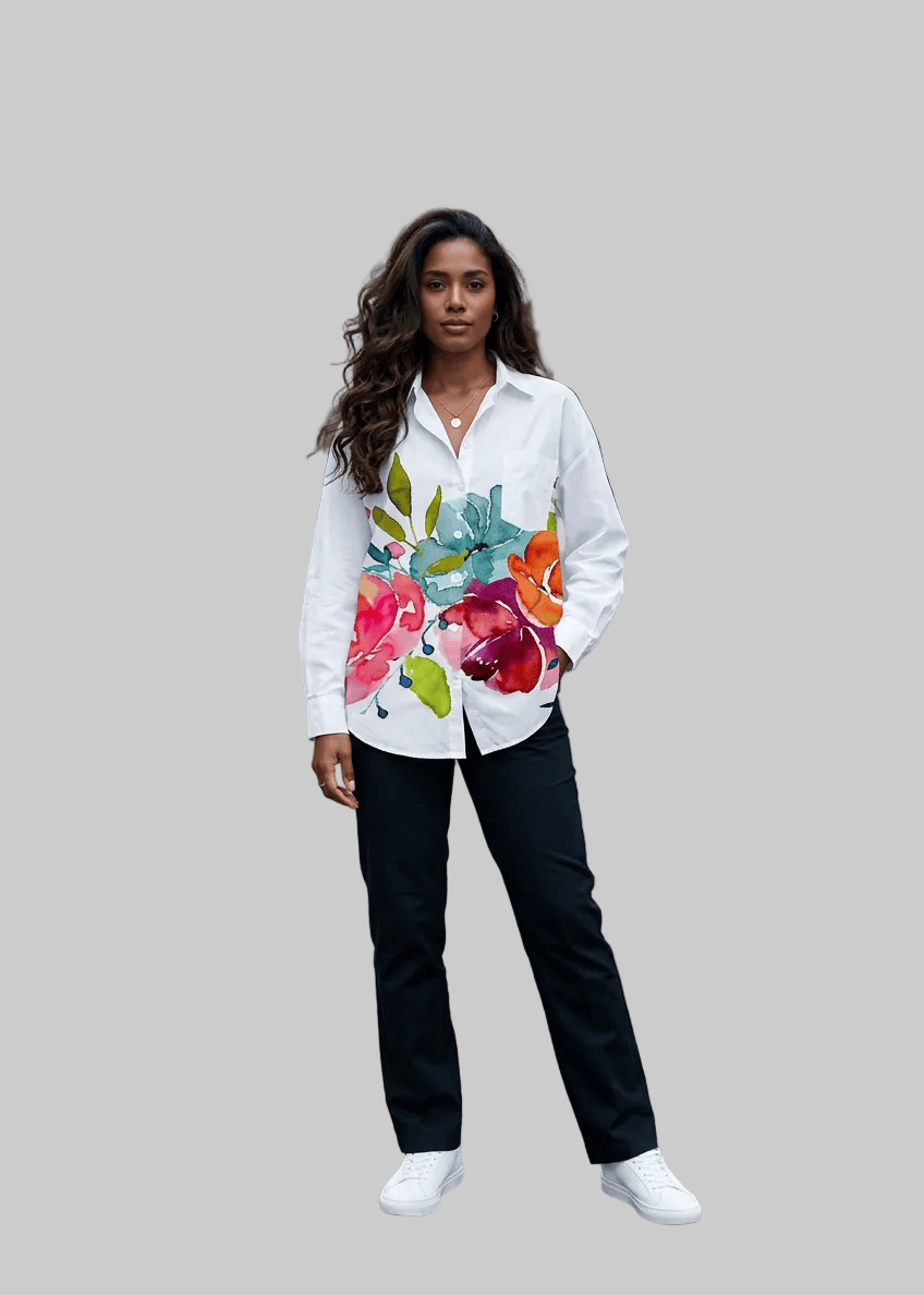 Woman wearing a colorful floral blouse and black pants on a city street with 'arvin' branding.