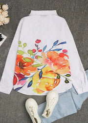 Floral-patterned shirt on a gray surface with white sneakers and a small plant.