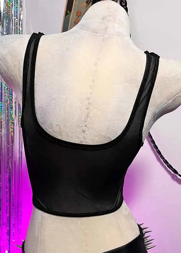 Black crop top on a mannequin with colorful fringe curtain in the background