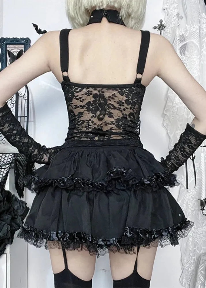 Person wearing a black lace dress with floral details in a decorative setting.