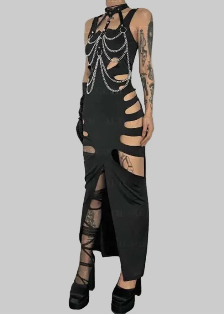 Black gothic dress with chain details worn by a person against a white wall.