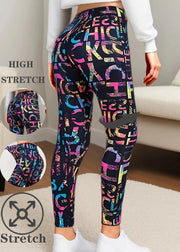 Colorful patterned leggings with text worn by a person indoors.
