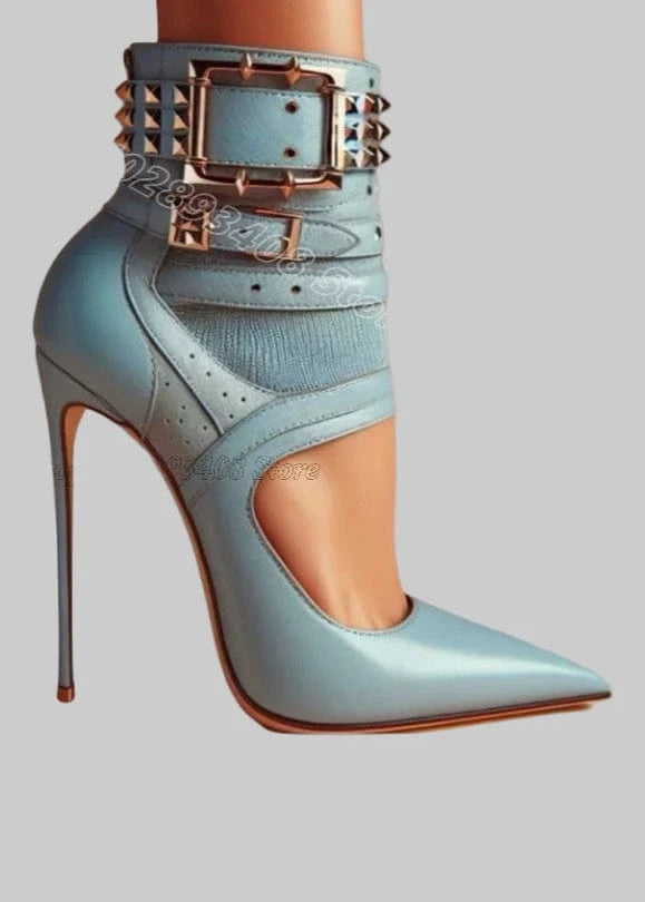 Mint green high-heeled shoe with studded details on a light blue background