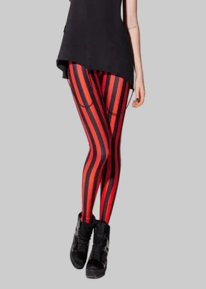 Red and black striped leggings worn by a person on a plain background