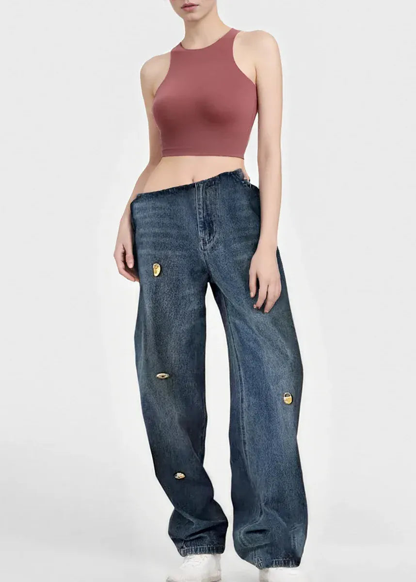 Person wearing a mauve crop top and blue jeans on a white background