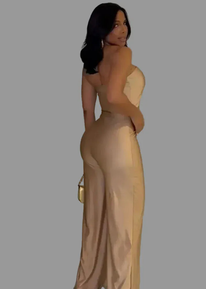 Woman in a beige evening gown standing against a neutral wall with 'FAGADOBR' branding.