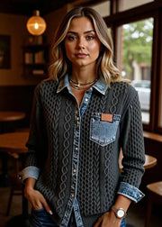 Woman standing in a casual setting with tables and chairs in the background