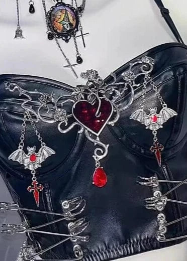 Black leather corset with silver and red embellishments on a white background