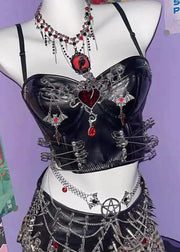 Black lingerie set with decorative elements on a mannequin against a purple wall.