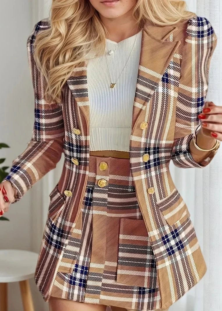 Woman wearing a plaid jacket and skirt with a white top indoors.