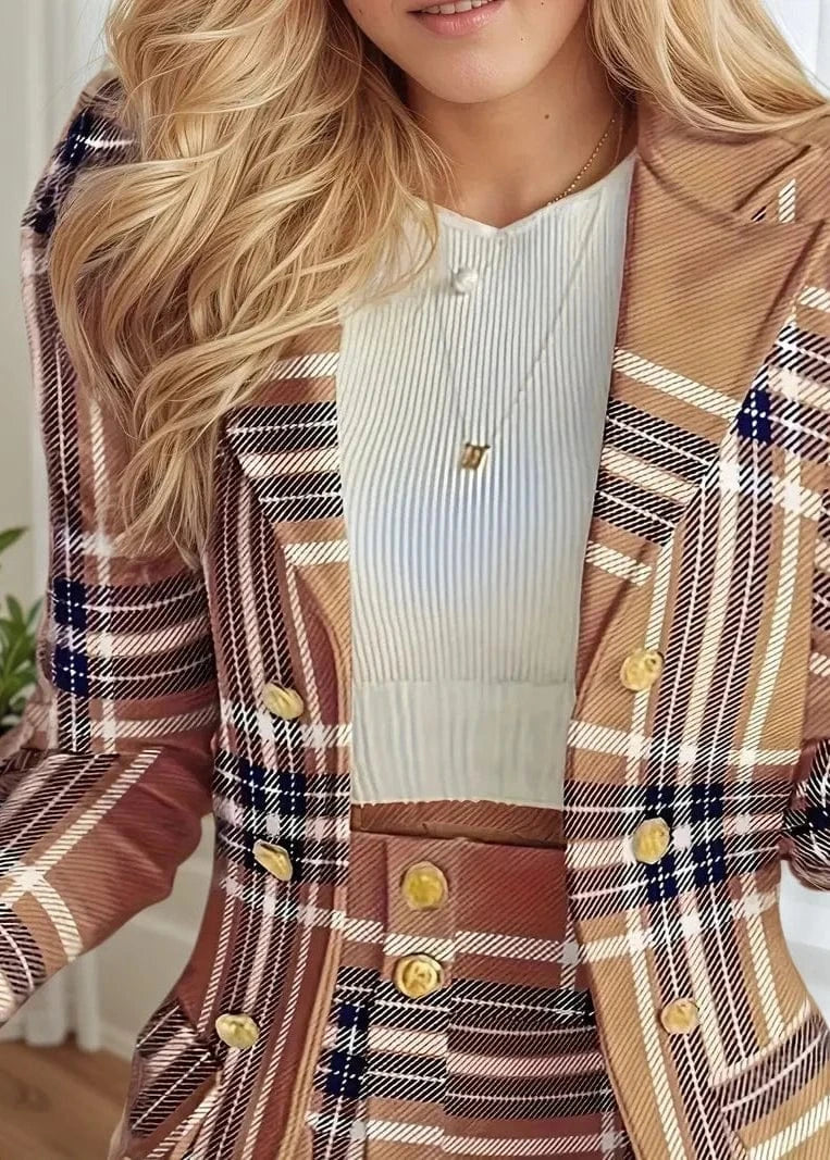 Person wearing a plaid coat with a white top and gold buttons.