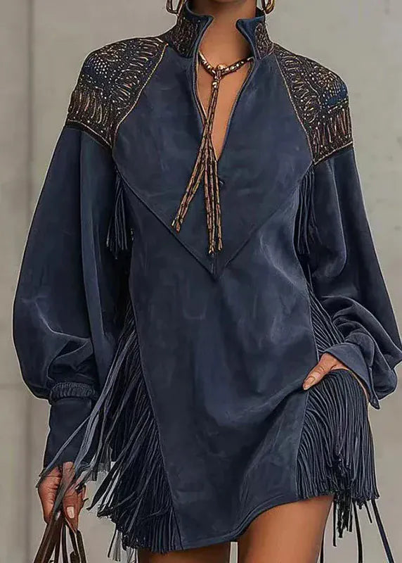 Navy blue dress with intricate detailing and fringes on a neutral background