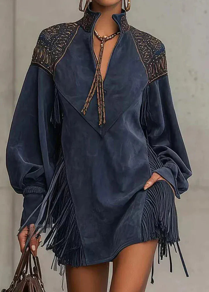 Navy blue dress with intricate patterns and fringes on a neutral background