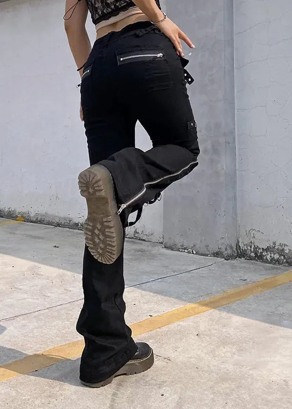 Person wearing black pants and boots in an urban setting