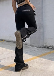 Person wearing black pants and boots in an urban setting