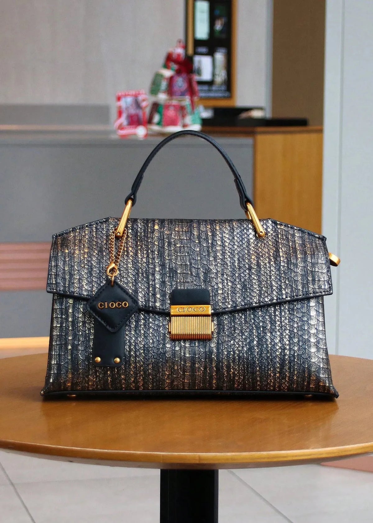 Designer handbag on a table with a blurred indoor background