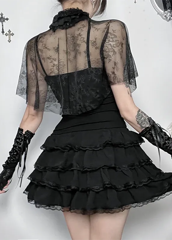 Person wearing a black lace dress with gloves in an ornate setting