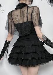 Person wearing a black lace dress with gloves in an ornate setting