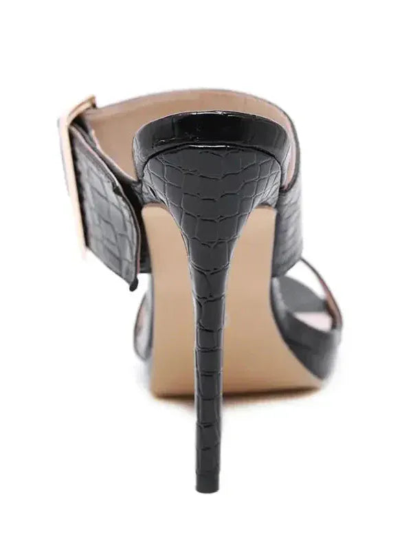 High-heeled shoe with a black snake-texture heel on a white background
