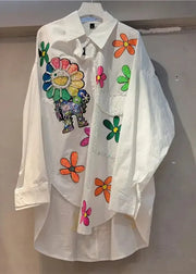 White shirt with colorful floral and animal designs on a plain background