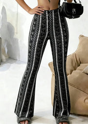 Person wearing black and white patterned pants with a blurred background