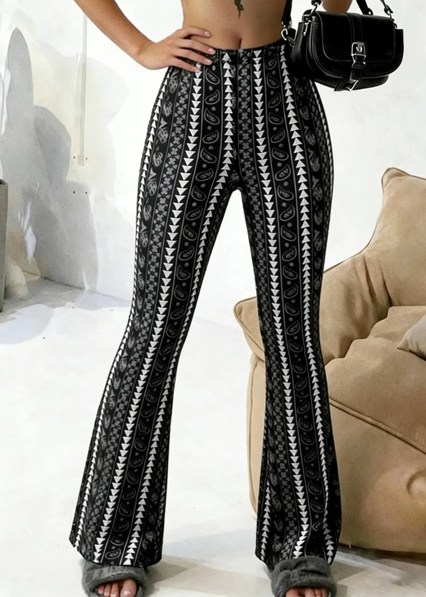 Person wearing black and white patterned pants with a blurred background