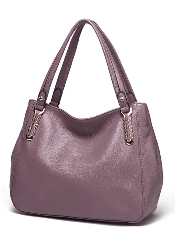 Purple handbag with gold accents on a white background