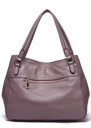 Purple handbag with a gold zipper on a white background