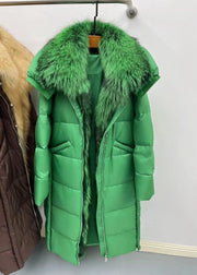 Green puffer coat with fur collar on a hanger against a plain background