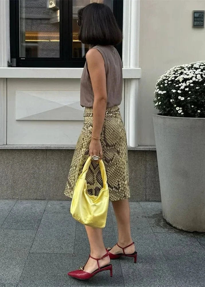 Woman holding a yellow bag in an urban setting